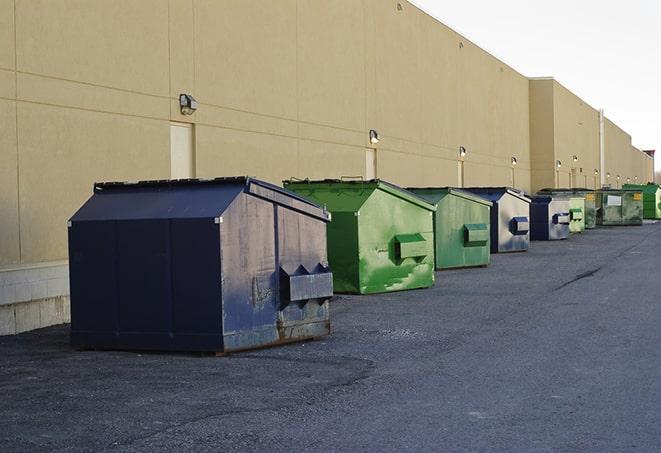 a construction worker moves construction materials near a dumpster in Campbell CA